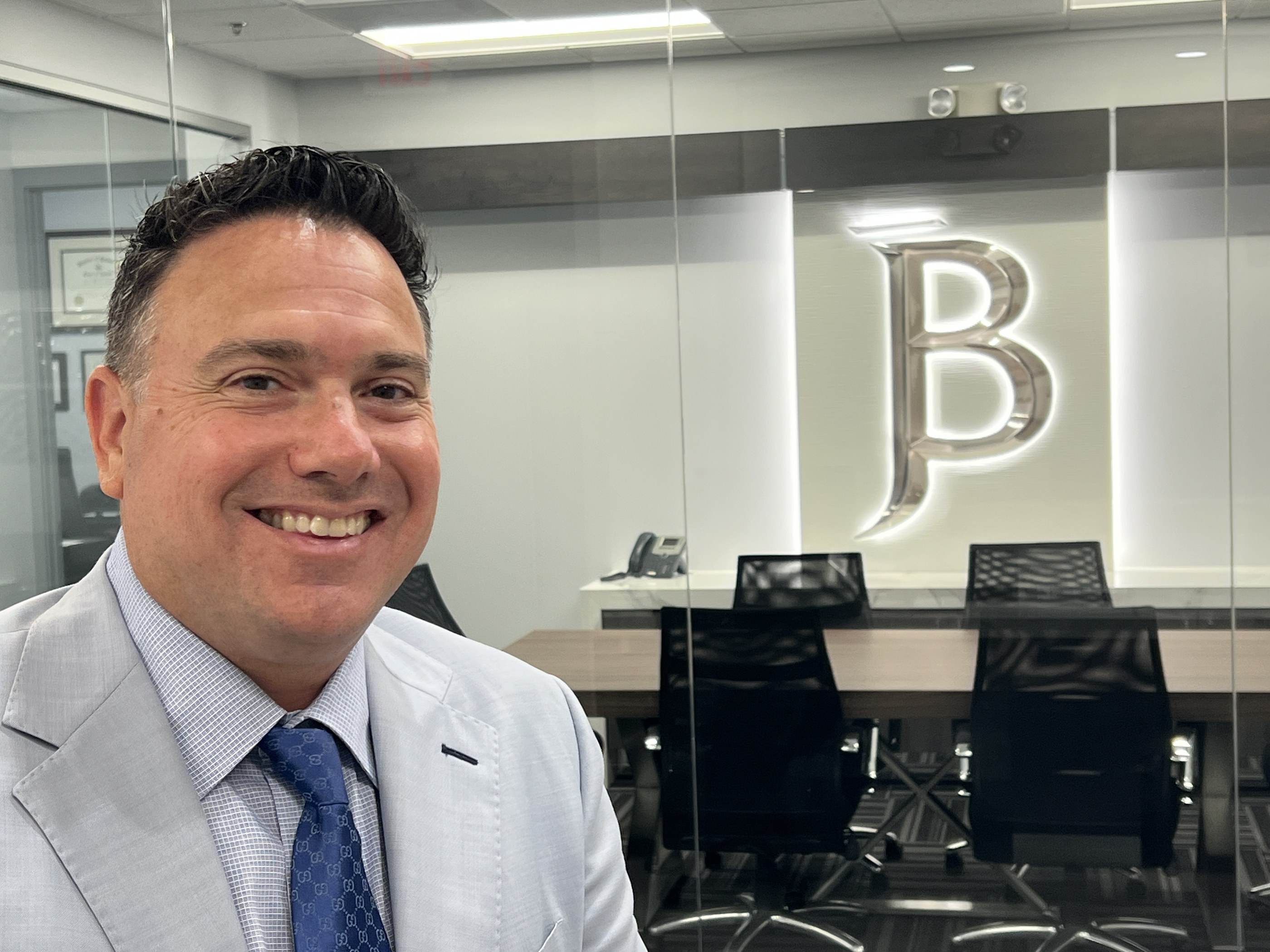 Jared F. Bossola in front of the conference room